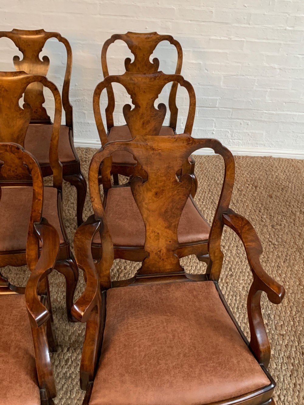 Set of six Queen Anne style burr walnut dining chairs with vasiform splat backs, padded brown fabric seats, and cabriole legs. View II