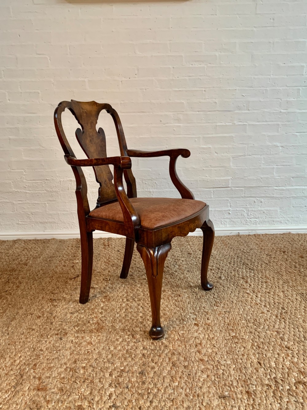 Set of six Queen Anne style burr walnut dining chairs with vasiform splat backs, padded brown fabric seats, and cabriole legs. View IV