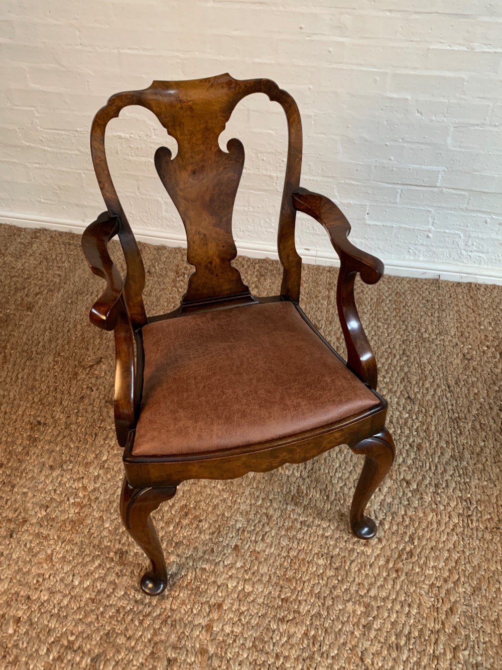Set of six Queen Anne style burr walnut dining chairs with vasiform splat backs, padded brown fabric seats, and cabriole legs. View V
