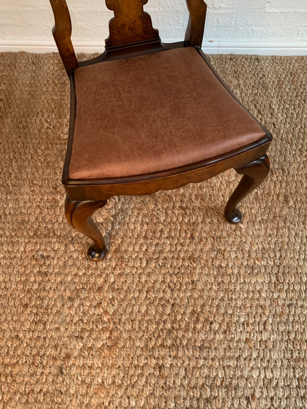 Set of six Queen Anne style burr walnut dining chairs with vasiform splat backs, padded brown fabric seats, and cabriole legs. View VI