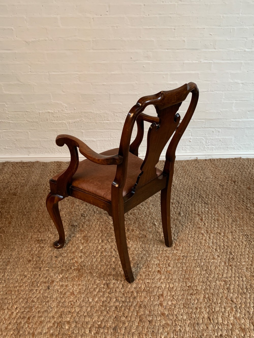 Set of six Queen Anne style burr walnut dining chairs with vasiform splat backs, padded brown fabric seats, and cabriole legs. View VII
