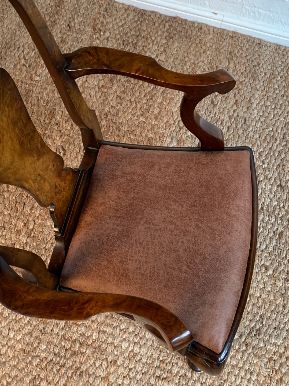 Set of six Queen Anne style burr walnut dining chairs with vasiform splat backs, padded brown fabric seats, and cabriole legs. View X