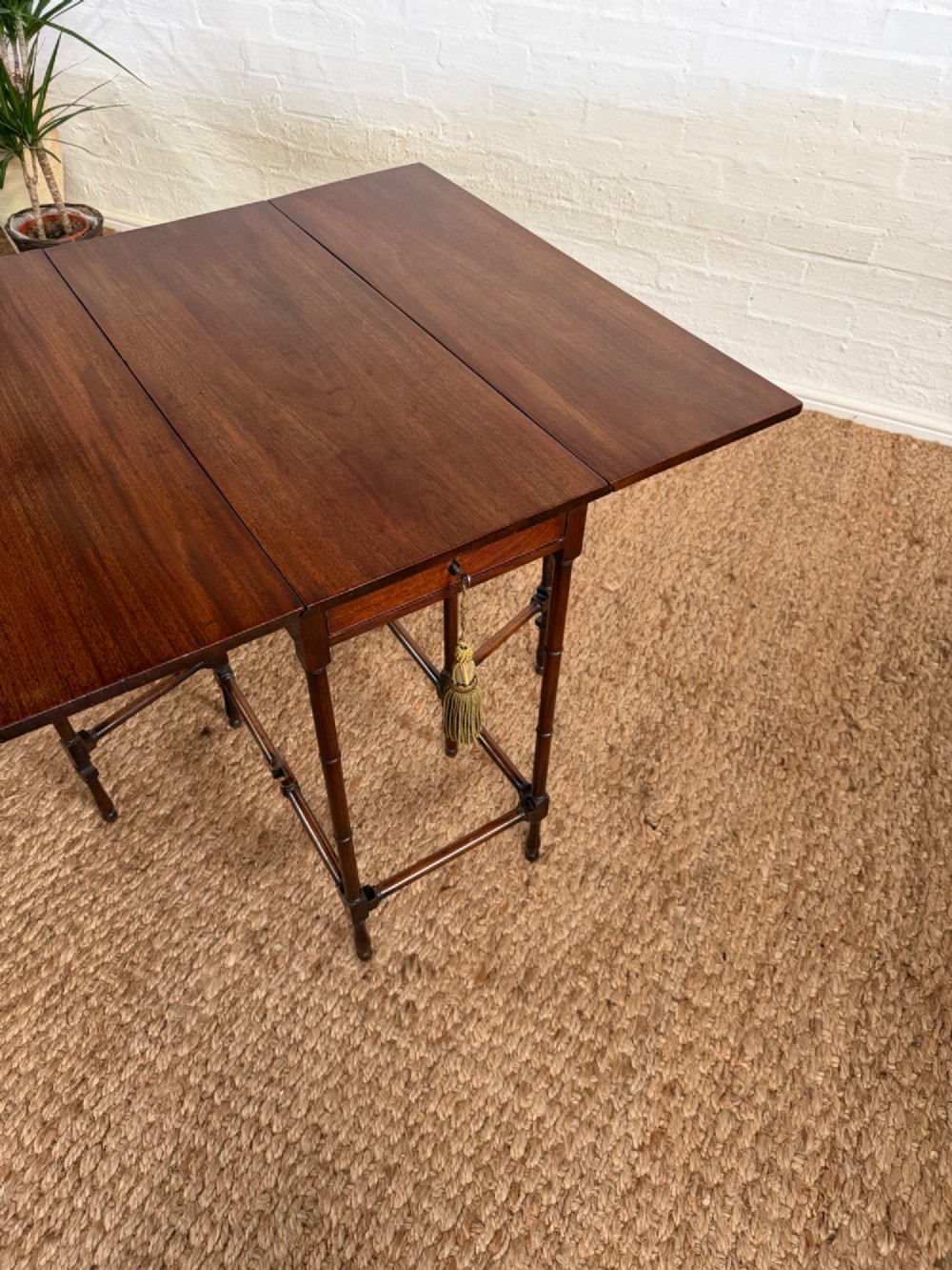 An Edwardian solid dark mahogany drop-leaf side table featuring turned faux-bamboo legs, a central drawer with a key, and a double-tier stretcher base. View III