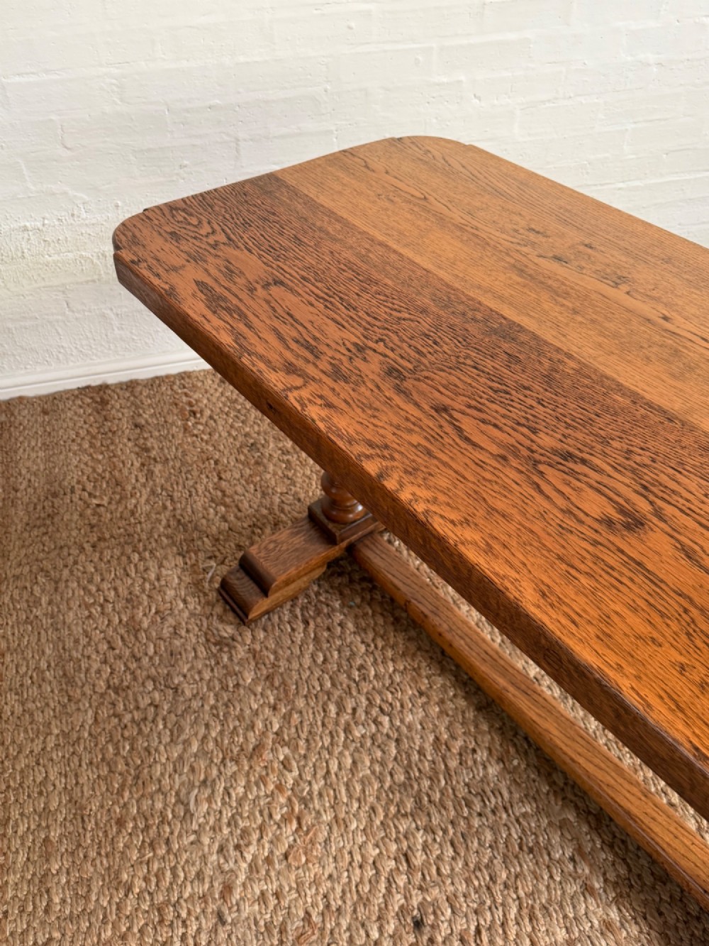 A small solid oak refectory style dining table featuring bulbous turned baluster legs and a floor-level central stretcher. View IV