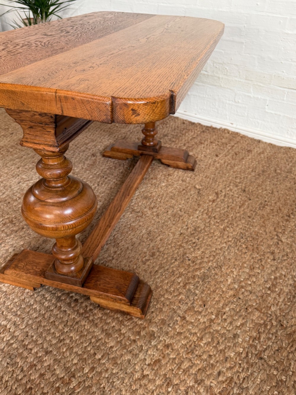 A small solid oak refectory style dining table featuring bulbous turned baluster legs and a floor-level central stretcher. View VI