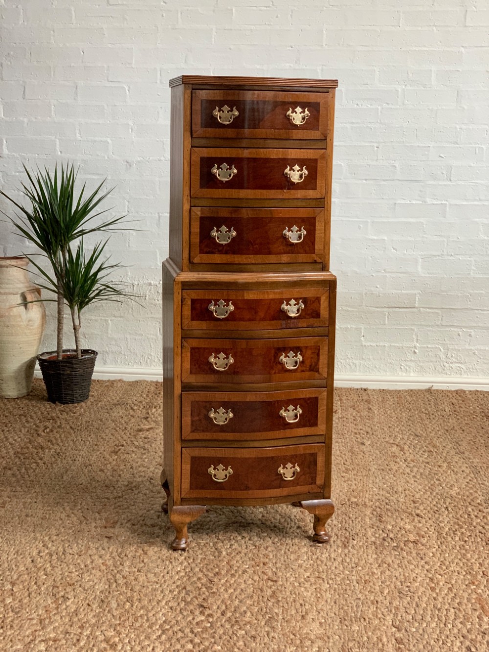 A narrow Queen Anne style walnut tallboy featuring seven drawers in a two-piece stacked design with brass handles and cabriole legs. View II