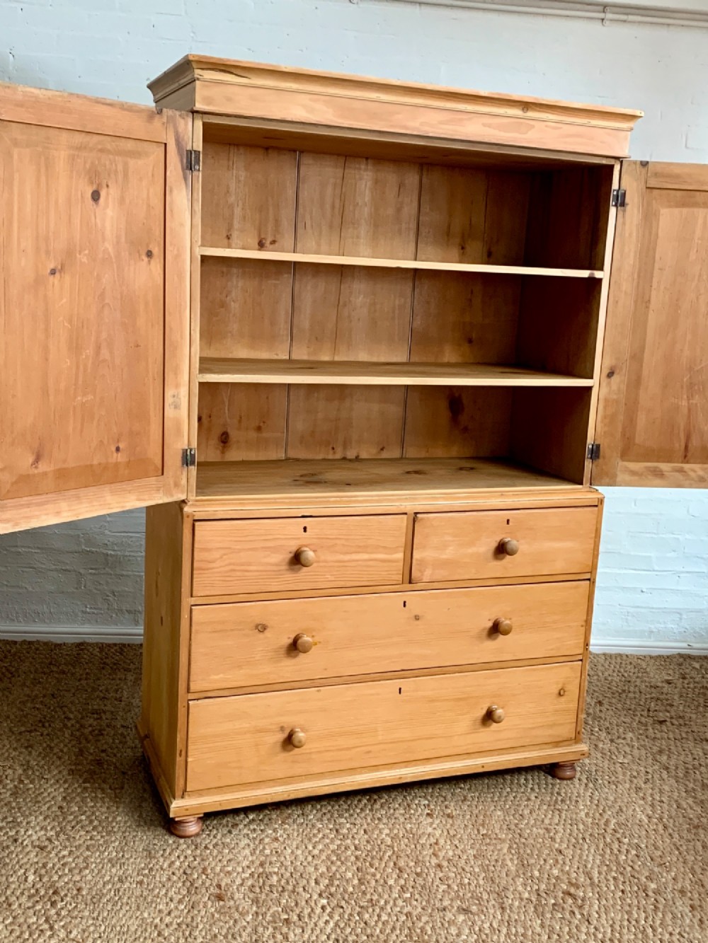 A two-piece late Victorian stripped pine dresser featuring a two-door upper cupboard and a base with two short over two long drawers with turned knobs. View III