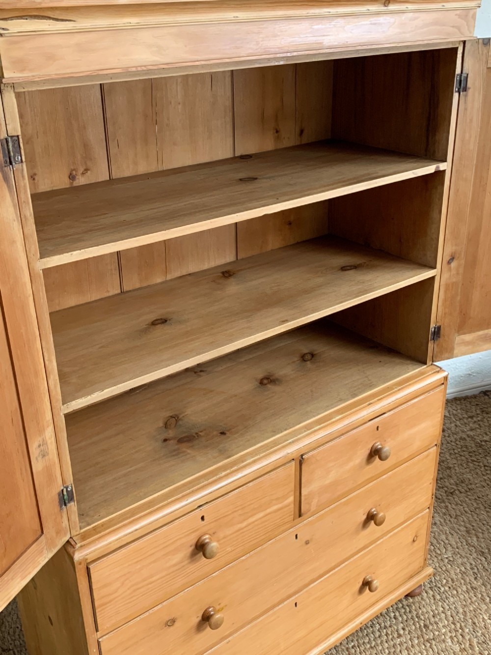 A two-piece late Victorian stripped pine dresser featuring a two-door upper cupboard and a base with two short over two long drawers with turned knobs. View IV