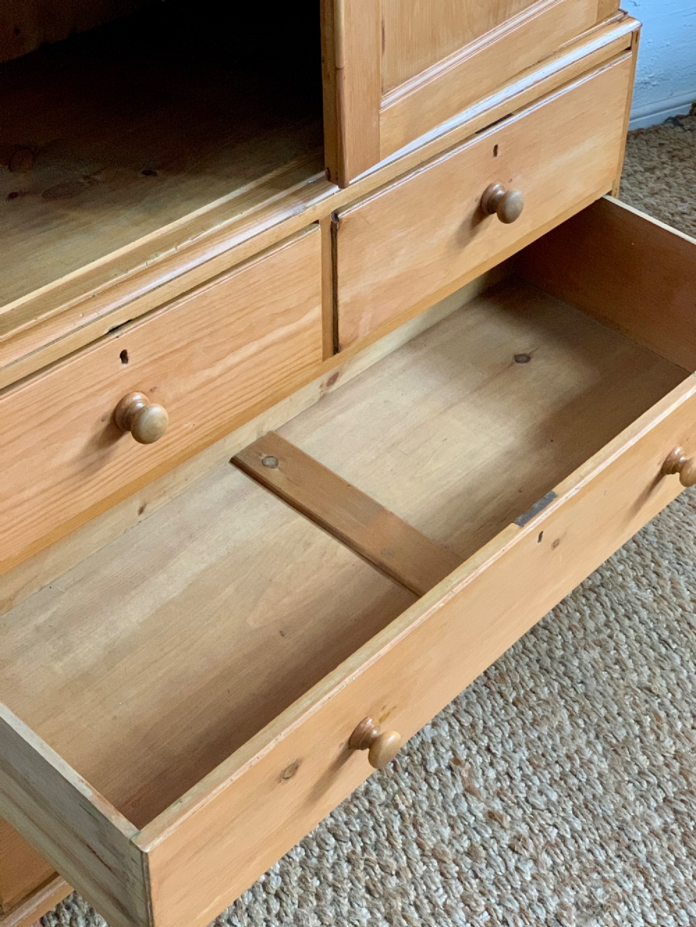 A two-piece late Victorian stripped pine dresser featuring a two-door upper cupboard and a base with two short over two long drawers with turned knobs. View VIII