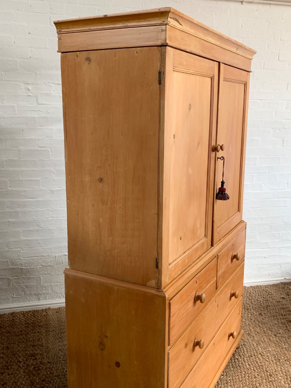 A two-piece late Victorian stripped pine dresser featuring a two-door upper cupboard and a base with two short over two long drawers with turned knobs. View IX