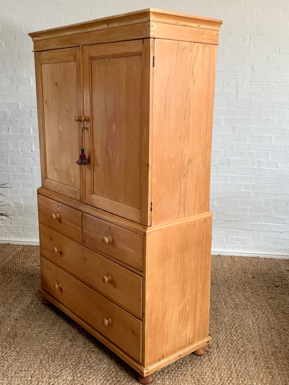 A two-piece late Victorian stripped pine dresser featuring a two-door upper cupboard and a base with two short over two long drawers with turned knobs. View XI