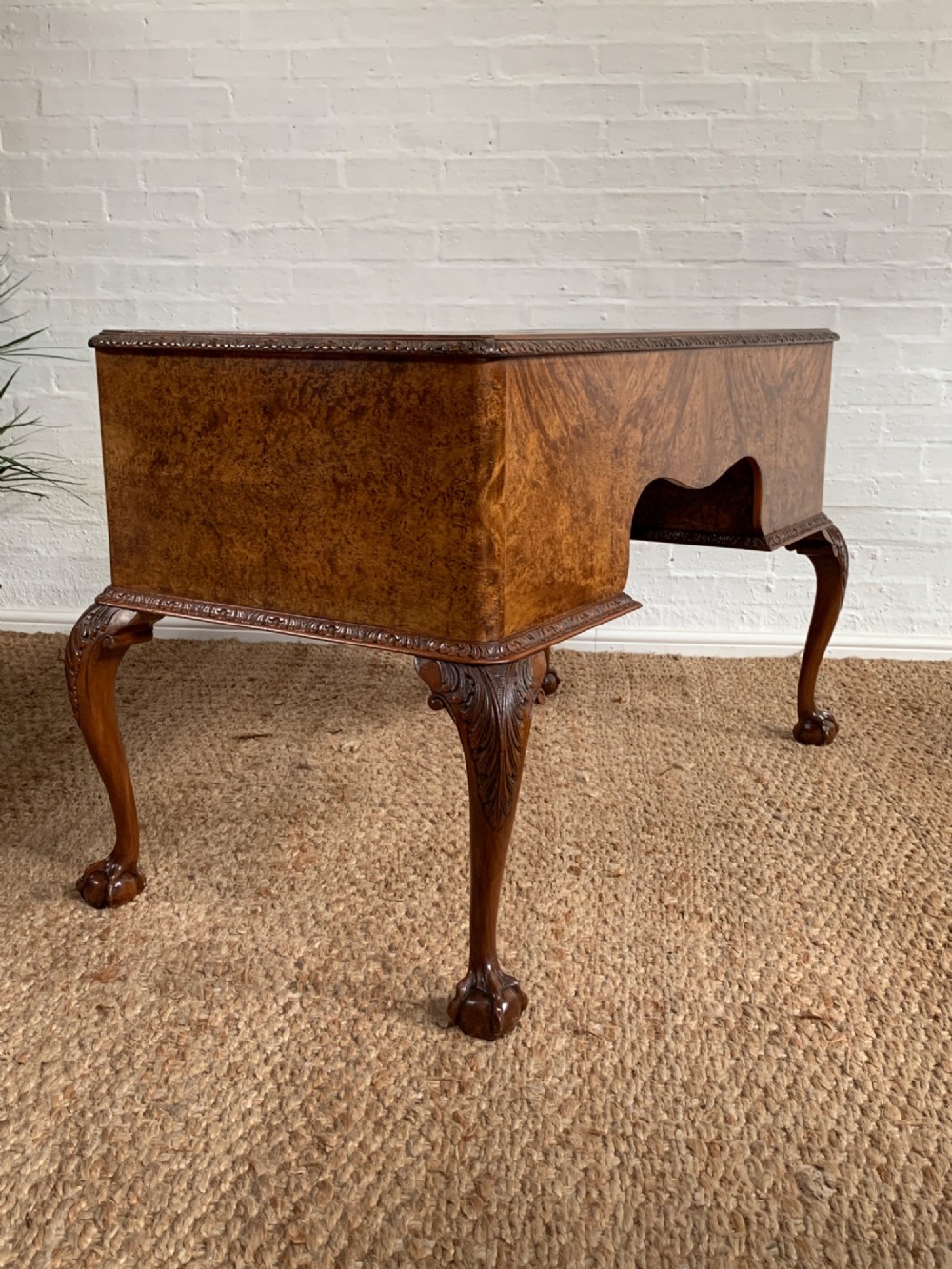 A burr walnut kneehole writing desk with four drawers, carved cabriole legs with claw and ball feet, and a green leather writing surface. View XII