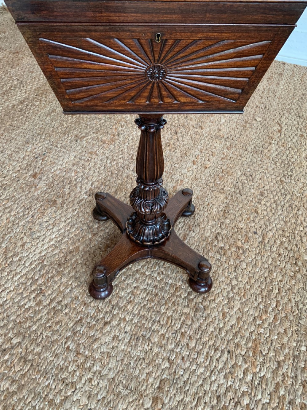 A dark rosewood William IV work table featuring a sunburst carved caddy top and side panels supported by a turned column pedestal and quadform base. View II