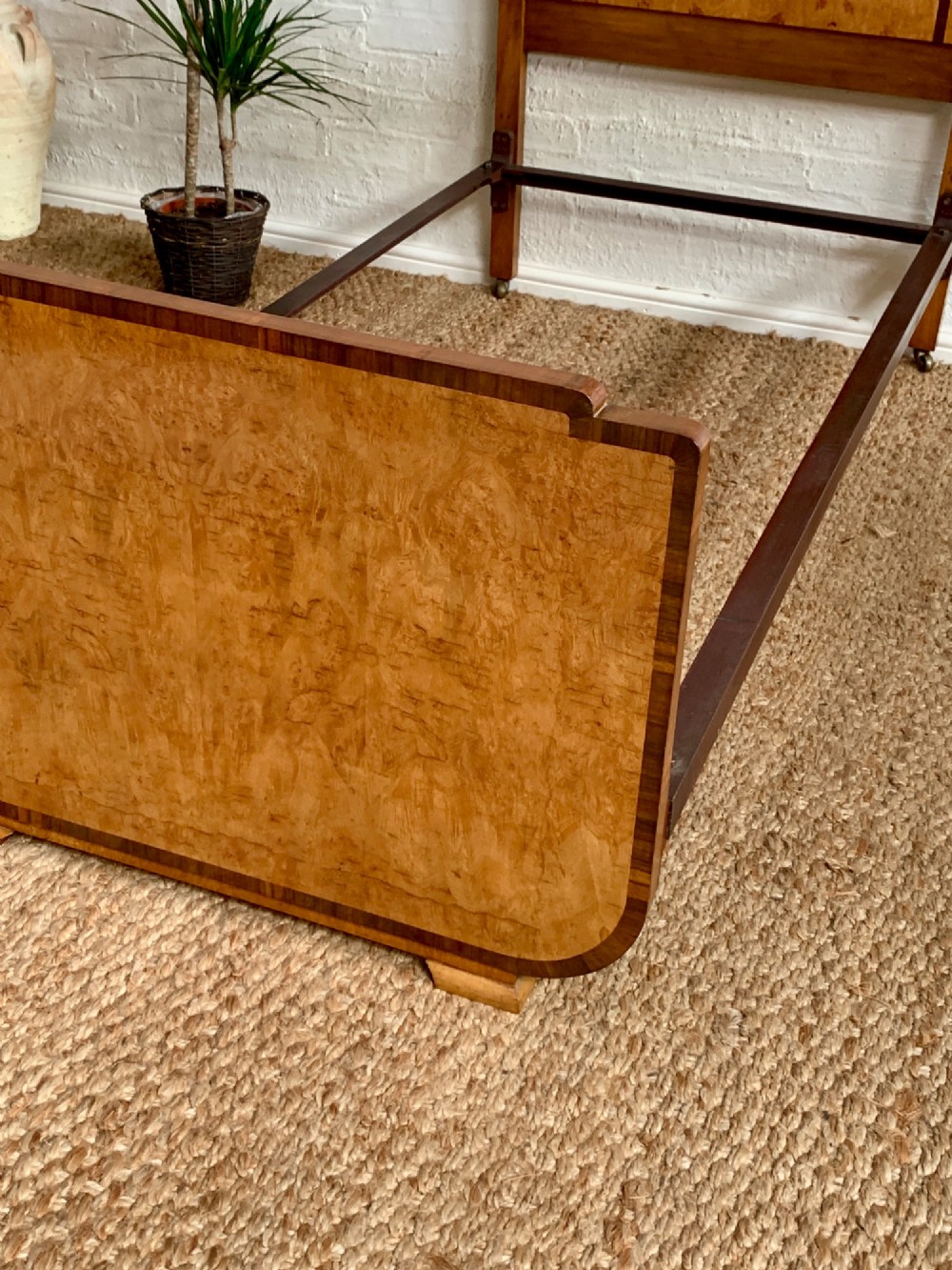 An Art Deco single bed frame crafted from figured burr walnut veneer with crossbanded borders, featuring a gently arched headboard and rounded footboard. View IV