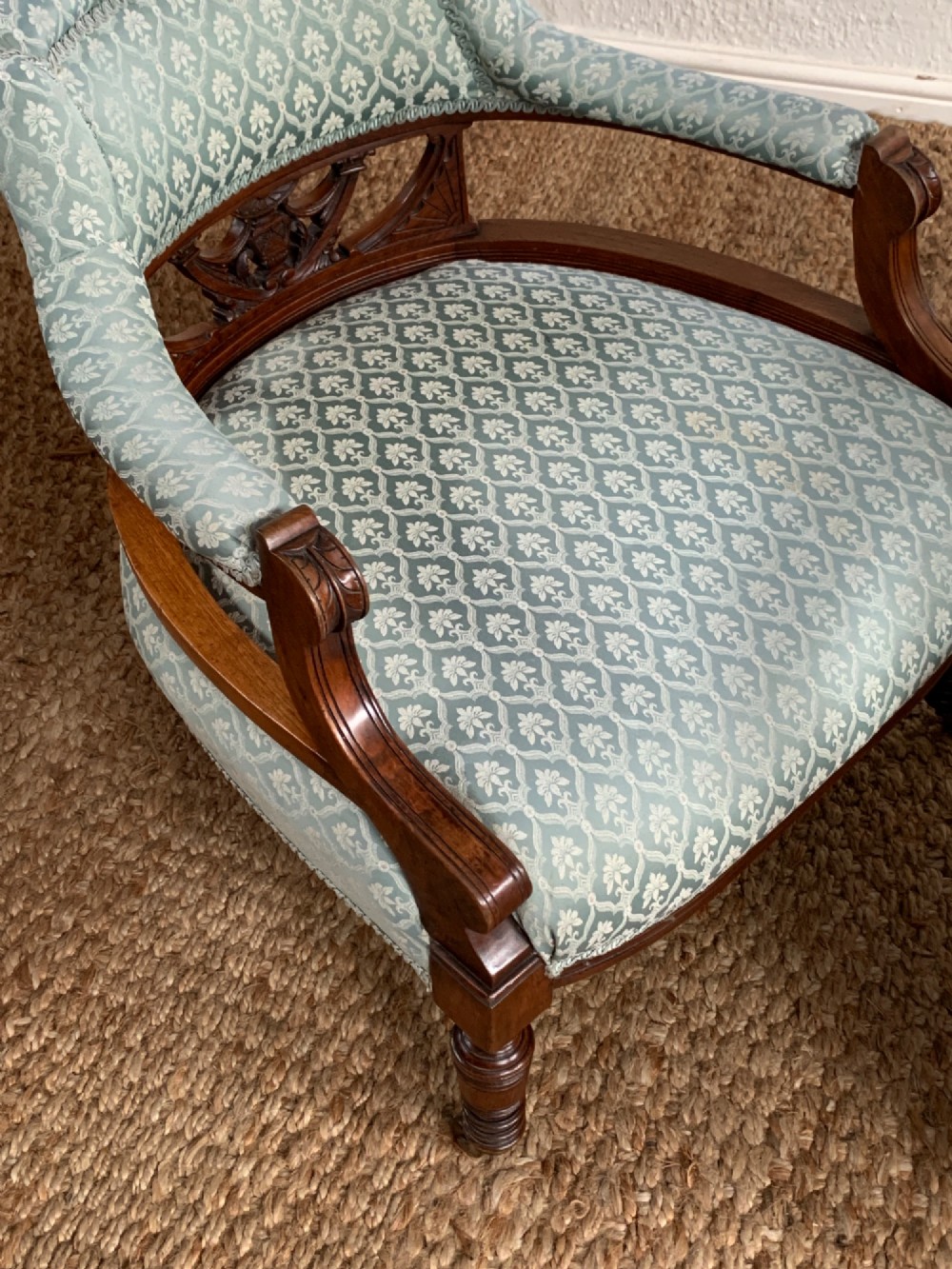 A pair of Edwardian walnut tub armchairs with pale blue patterned upholstery, turned front legs, and castors. View VII