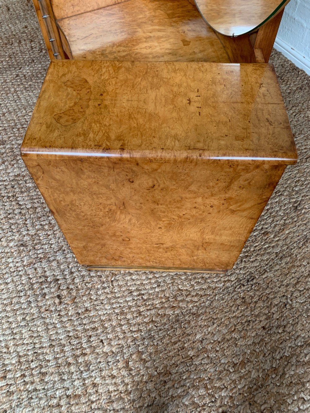 An Art Deco burr walnut dressing table featuring a circular mirror, twin pedestals, and vertical drawer handles. View VI