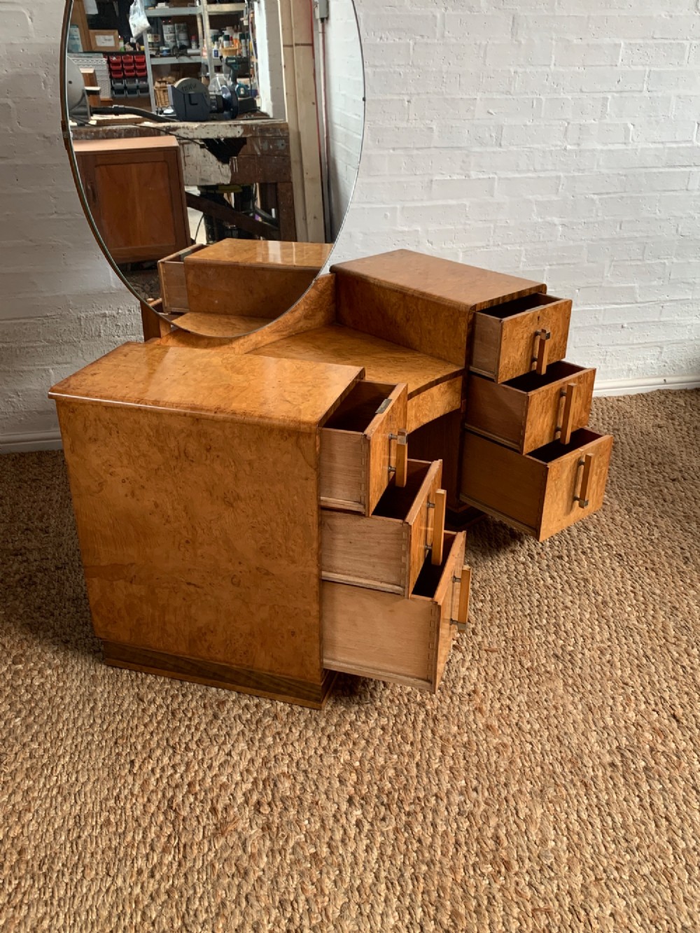 An Art Deco burr walnut dressing table featuring a circular mirror, twin pedestals, and vertical drawer handles. View VIII