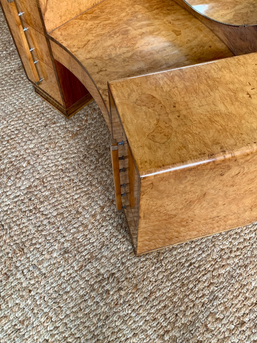 An Art Deco burr walnut dressing table featuring a circular mirror, twin pedestals, and vertical drawer handles. View IX