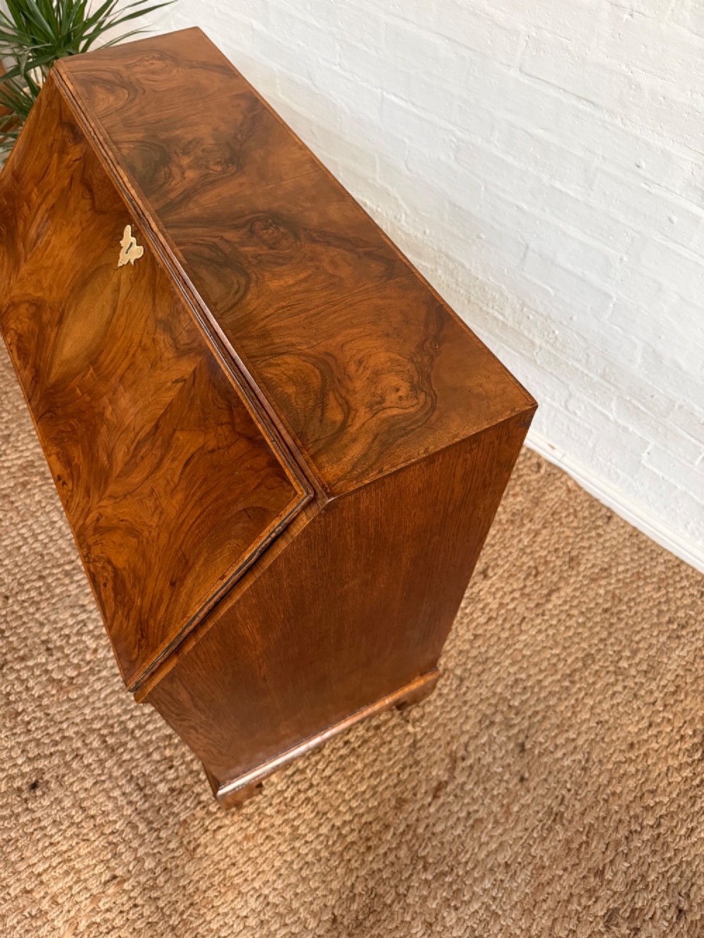 A Georgian period figured walnut bureau featuring a slant front flap above four graduated drawers with brass handles, resting on bracket feet. View II