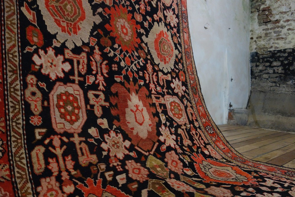 A long 19th-century Caucasian Kuba kelleh corridor runner rug featuring geometric medallions on a dark blue field framed by a terracotta border. View XII