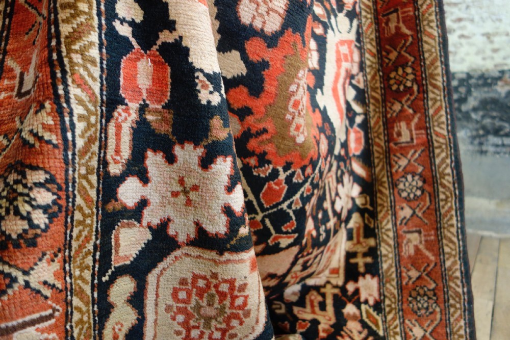 A long 19th-century Caucasian Kuba kelleh corridor runner rug featuring geometric medallions on a dark blue field framed by a terracotta border. View VII