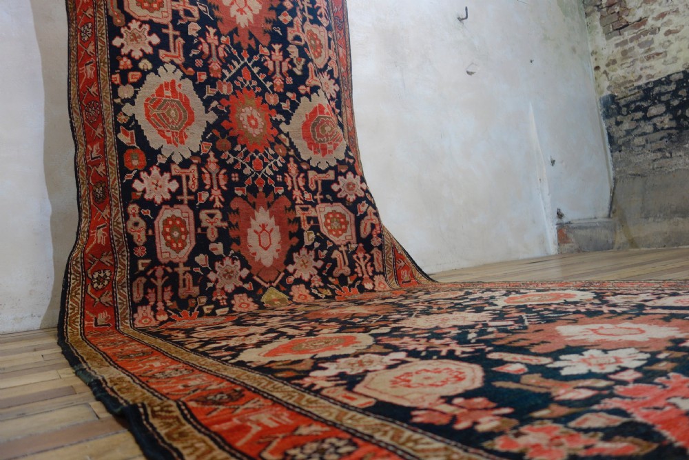 A long 19th-century Caucasian Kuba kelleh corridor runner rug featuring geometric medallions on a dark blue field framed by a terracotta border. View XI