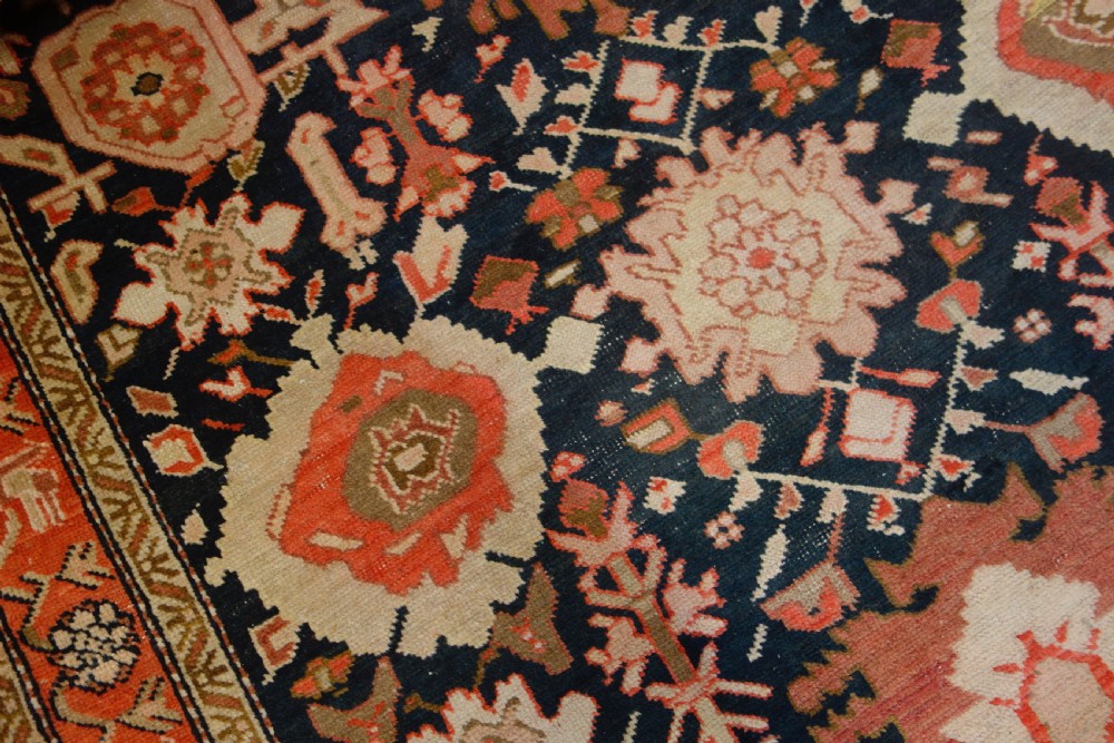 A long 19th-century Caucasian Kuba kelleh corridor runner rug featuring geometric medallions on a dark blue field framed by a terracotta border. View XIII