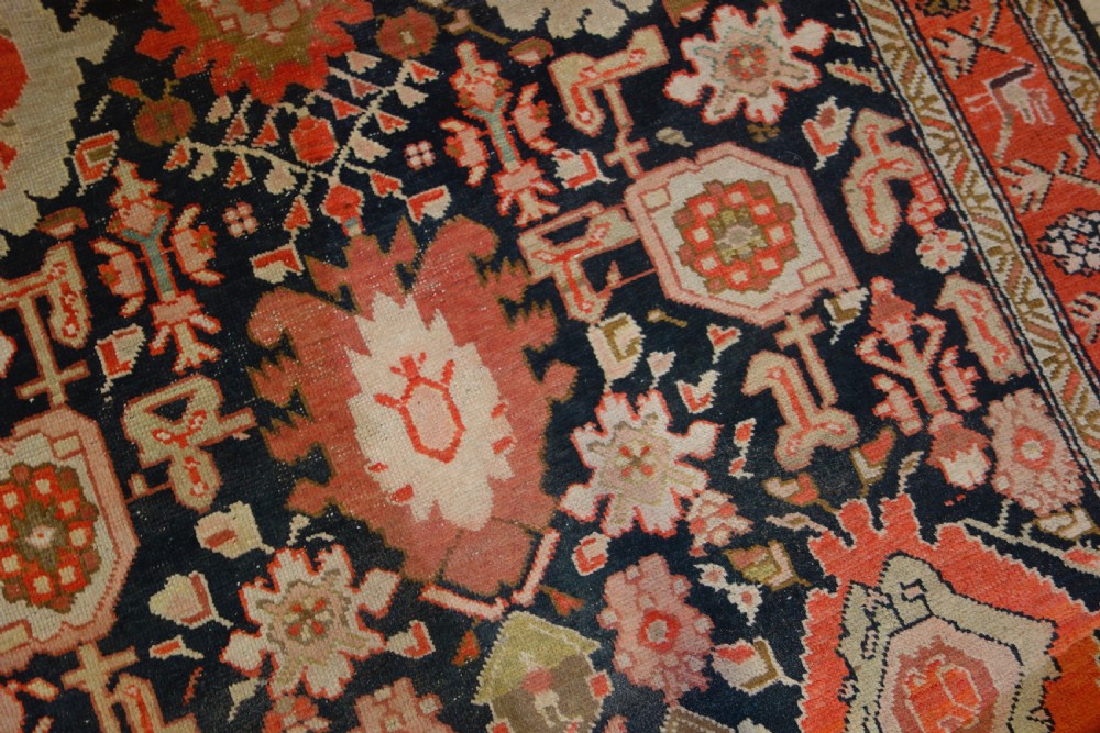 A long 19th-century Caucasian Kuba kelleh corridor runner rug featuring geometric medallions on a dark blue field framed by a terracotta border. View XIV