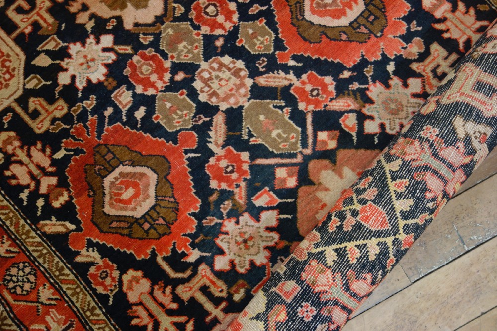 A long 19th-century Caucasian Kuba kelleh corridor runner rug featuring geometric medallions on a dark blue field framed by a terracotta border. View XV