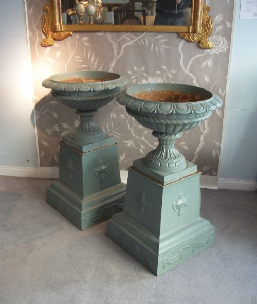 PAIR OF ELEGANT CAST IRON URNS ON PLINTHS - ADDITIONAL PHOTO 1