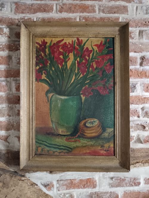 fig 1. An 1896 post-impressionist oil painting depicting red flowers in a green vase alongside a wooden box and beads, set within a moulded frame.