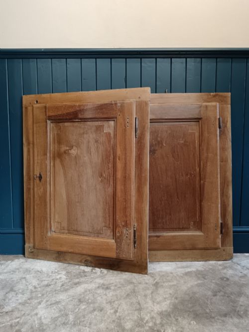 fig 1. A pair of antique Italian walnut cupboard doors set within rectangular timber frames with recessed panels and iron hardware.