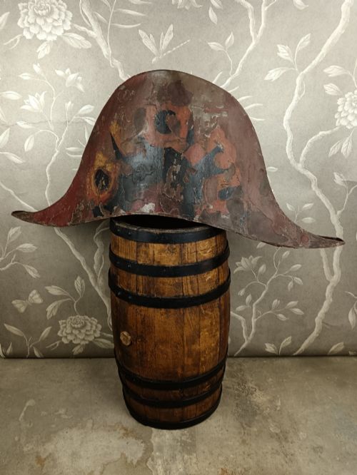 fig 3. A nineteenth-century painted toleware trade sign shaped in the form of a military bicorn hat with gilt detailing.
