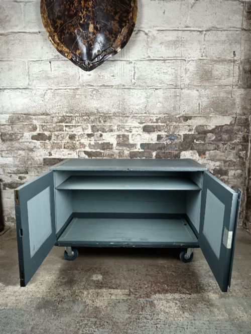 fig 2. A slate grey painted 19th-century military campaign packing chest with iron flush handles, corner reinforcements, hinged doors, and an internal shelf.
