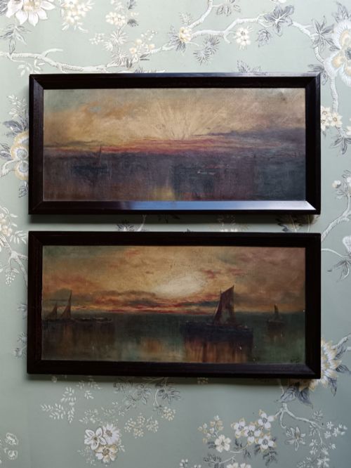 fig 1. A pair of framed horizontal Edwardian oil paintings depicting atmospheric maritime scenes with sailboats at sunrise and sunset.