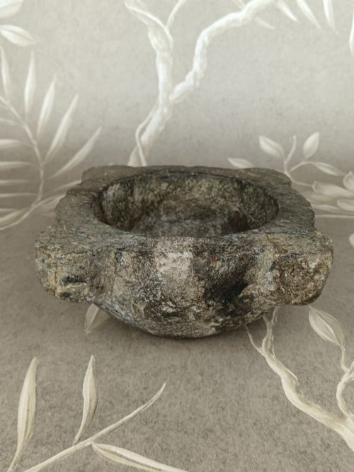 fig 3. An antique hand-carved stone mortar featuring four corner lugs, shown with a turned fruitwood pestle.