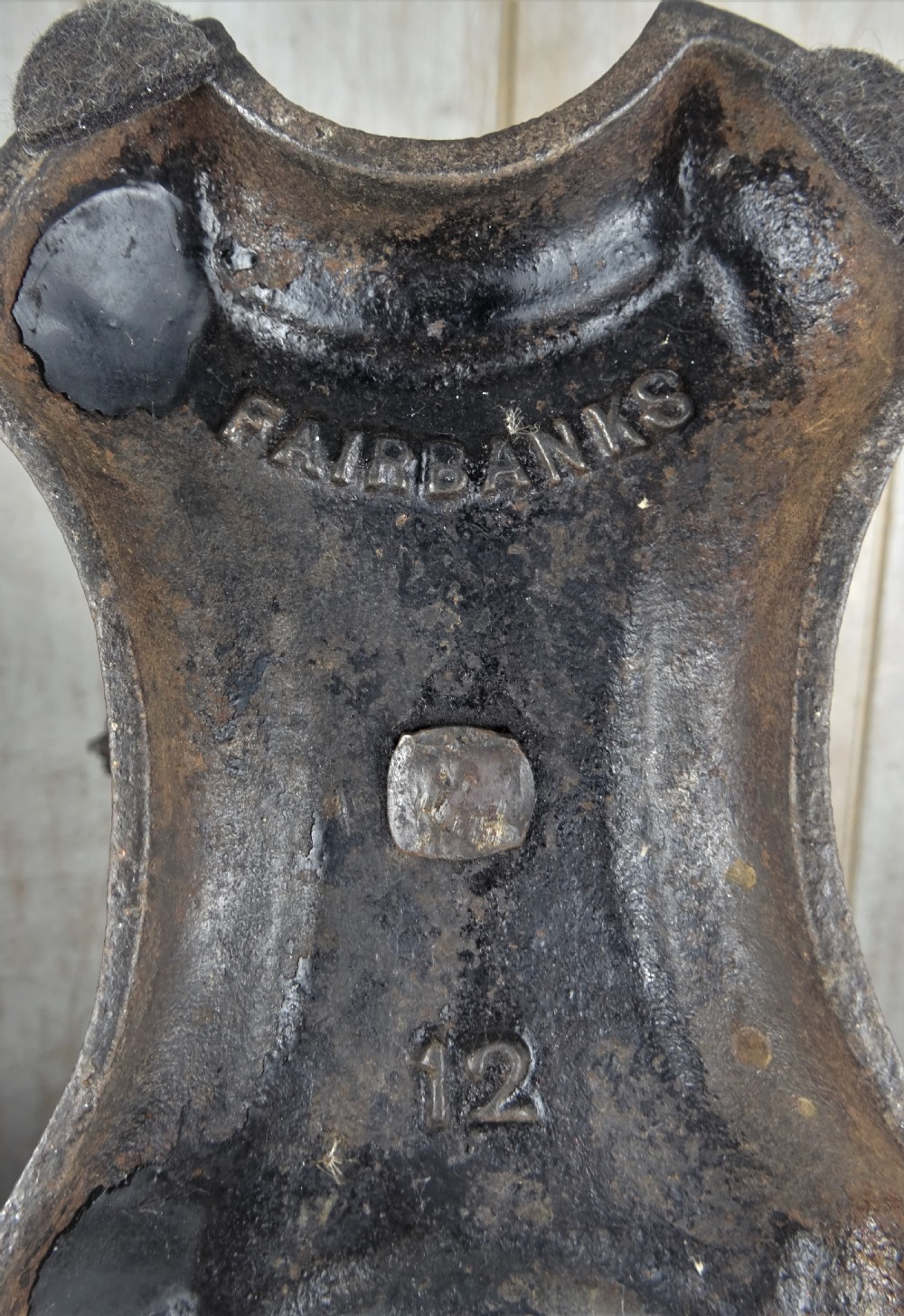A Victorian cast iron balance scale featuring a central twisted column support, a horizontal balance beam, and two hanging metal pans. View VIII