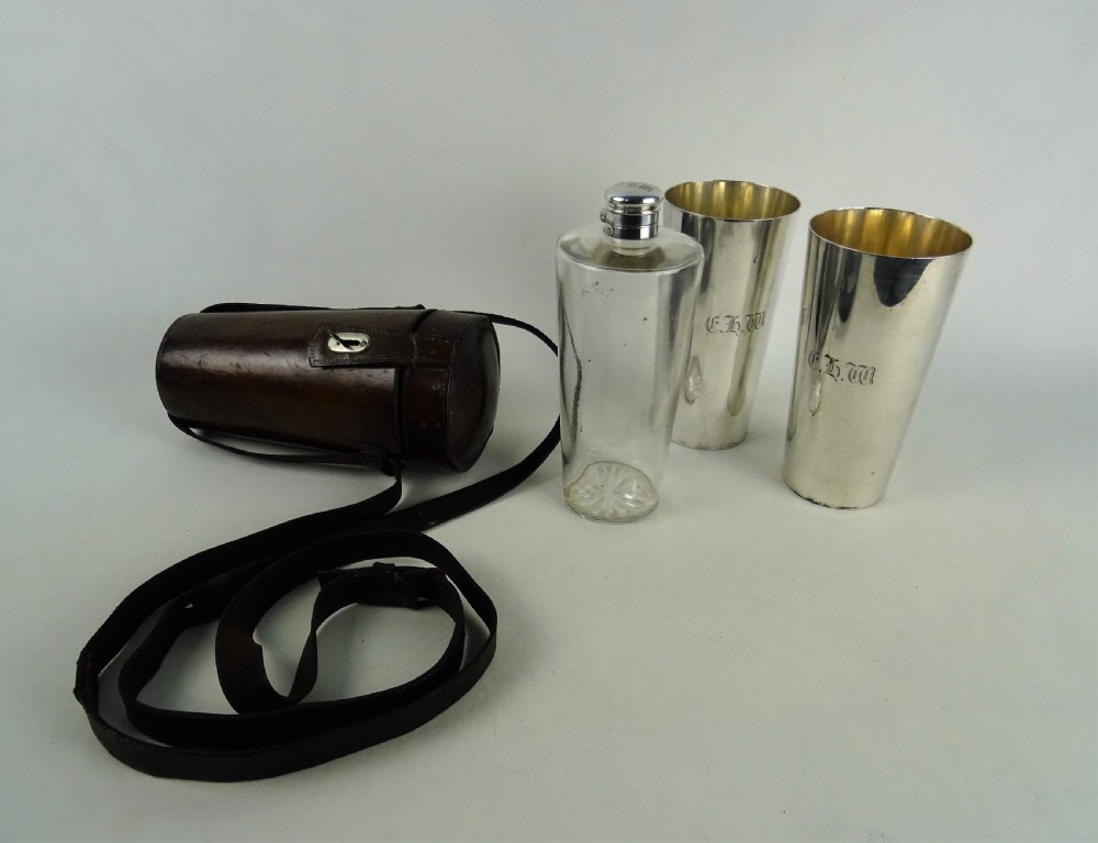 A nineteenth-century glass spirit flask encased in a dark brown leather carrying case with a leather shoulder strap and silver-toned metal cap. View XI