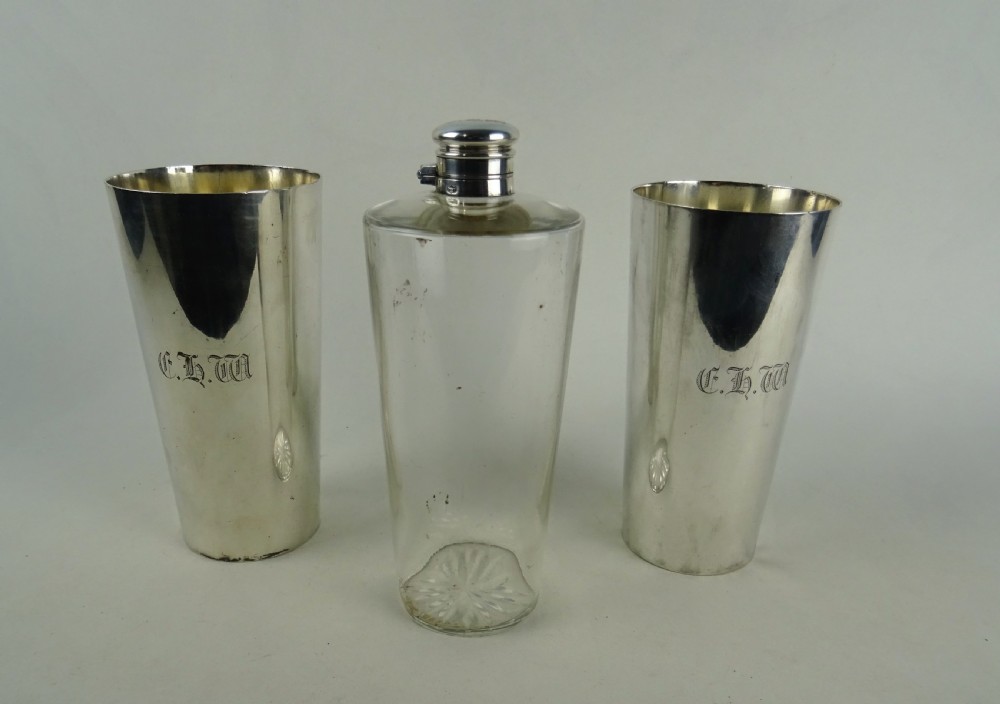 A nineteenth-century glass spirit flask encased in a dark brown leather carrying case with a leather shoulder strap and silver-toned metal cap. View VII