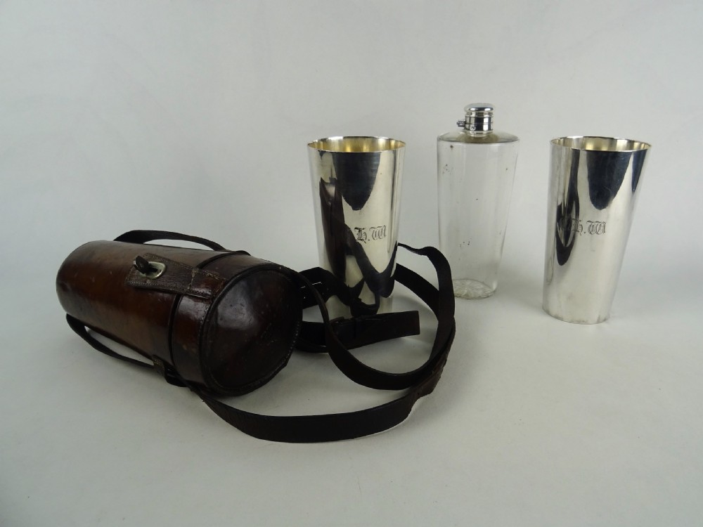 A nineteenth-century glass spirit flask encased in a dark brown leather carrying case with a leather shoulder strap and silver-toned metal cap. View XII