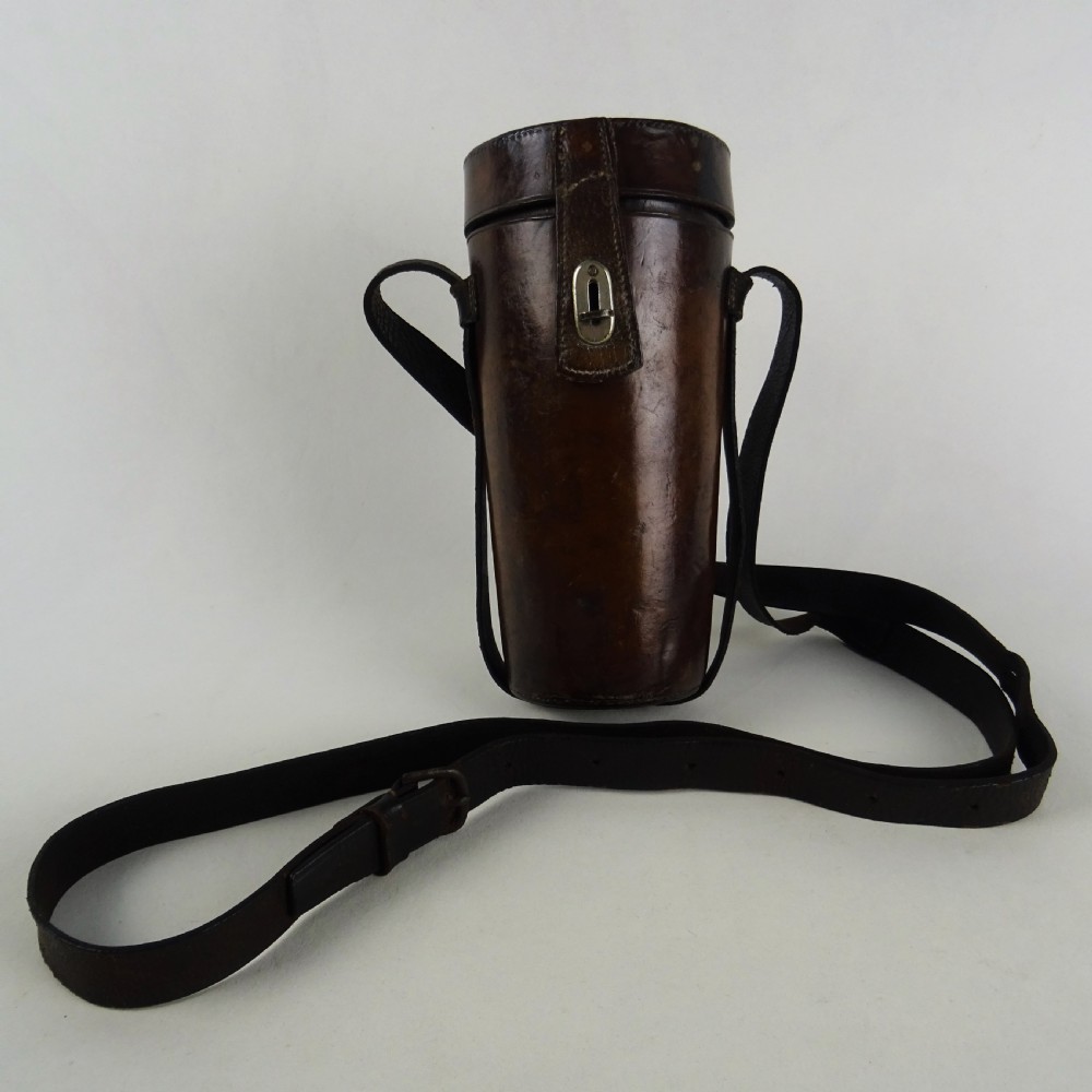 A nineteenth-century glass spirit flask encased in a dark brown leather carrying case with a leather shoulder strap and silver-toned metal cap. View XIV