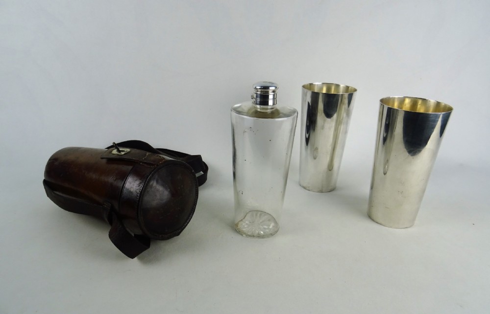 A nineteenth-century glass spirit flask encased in a dark brown leather carrying case with a leather shoulder strap and silver-toned metal cap. View VIII