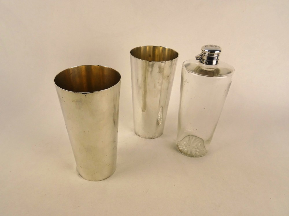 A nineteenth-century glass spirit flask encased in a dark brown leather carrying case with a leather shoulder strap and silver-toned metal cap. View X