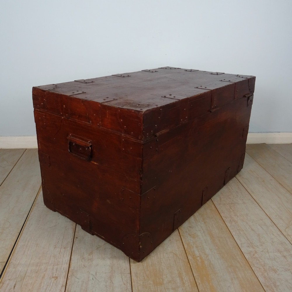 A large 19th-century dark timber campaign trunk featuring metal corner strapping, side carrying handles, and a hinged lid. View XVI