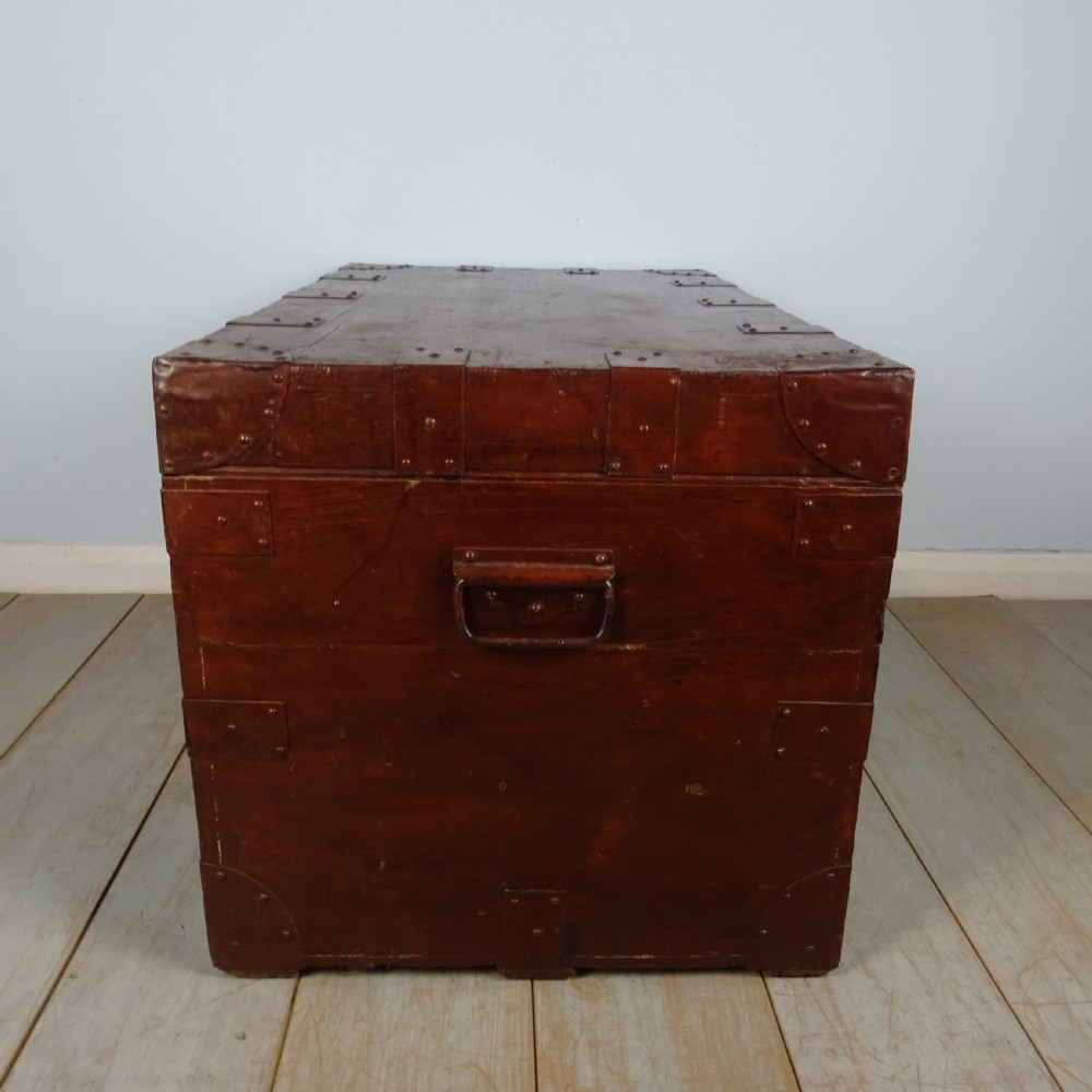 A large 19th-century dark timber campaign trunk featuring metal corner strapping, side carrying handles, and a hinged lid. View VIII
