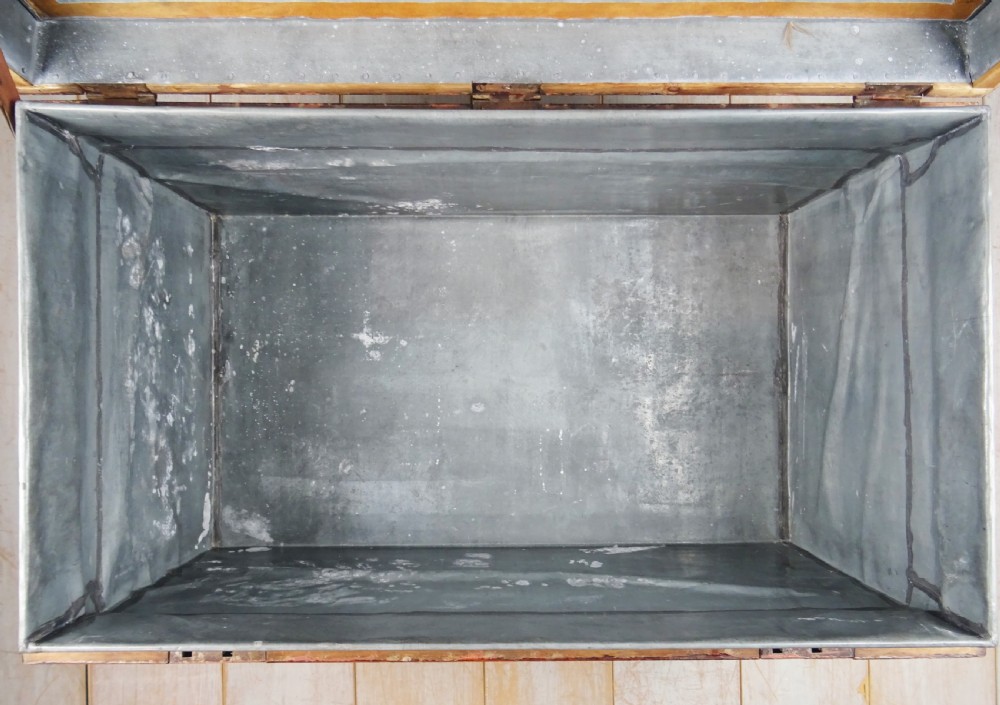 A large 19th-century dark timber campaign trunk featuring metal corner strapping, side carrying handles, and a hinged lid. View III