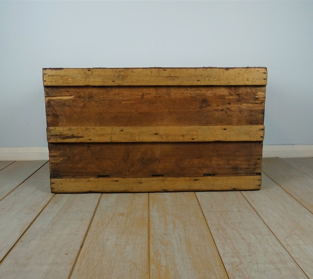 A large 19th-century dark timber campaign trunk featuring metal corner strapping, side carrying handles, and a hinged lid. View XVII