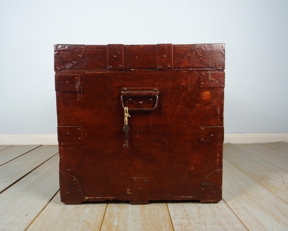 A large 19th-century dark timber campaign trunk featuring metal corner strapping, side carrying handles, and a hinged lid. View IX