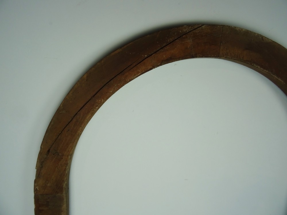 A group of three antique Italian walnut wooden door frames featuring rounded arches and moulded profiles. View XIII