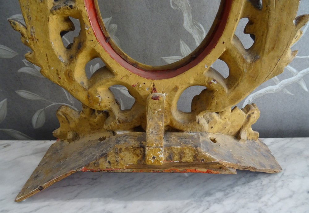 A pair of antique Italian Baroque carved giltwood oval frames with intricate acanthus leaf ornamentation and integrated standing bases. View II
